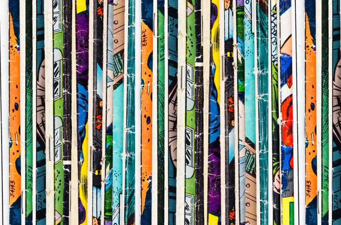 Person searching through stacked comic books