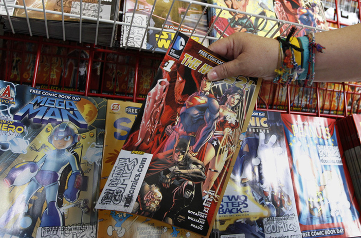 Person reviewing comic book sale offers