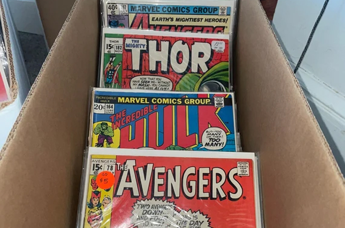 Person cleaning and pressing a comic book