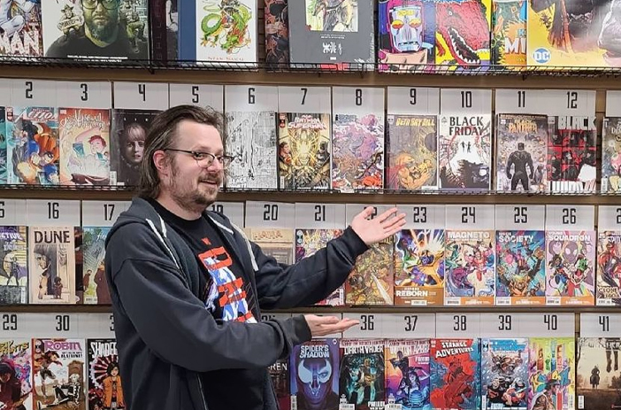 Comic books stacked with price tags visible