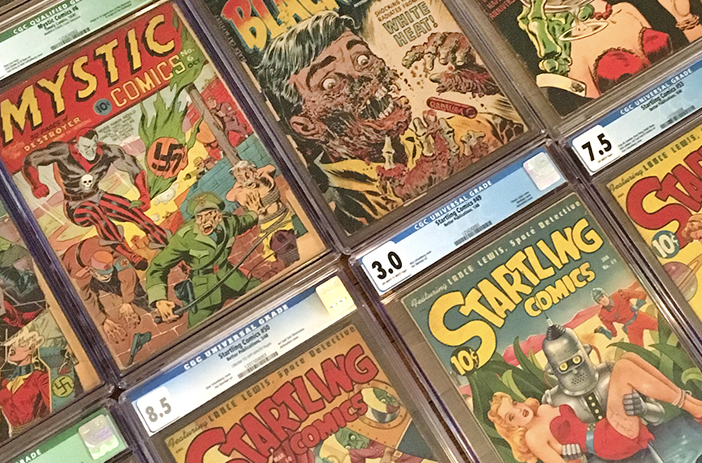 Person sorting through stack of comic books