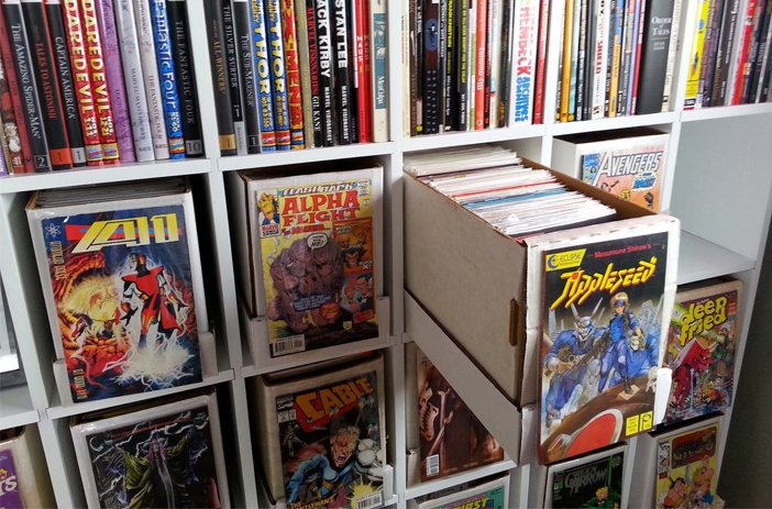 Person sorting through stack of comic books