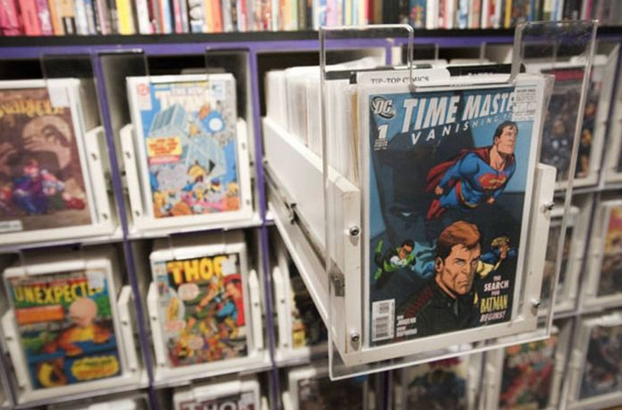 Comic book appraiser examining rare issue