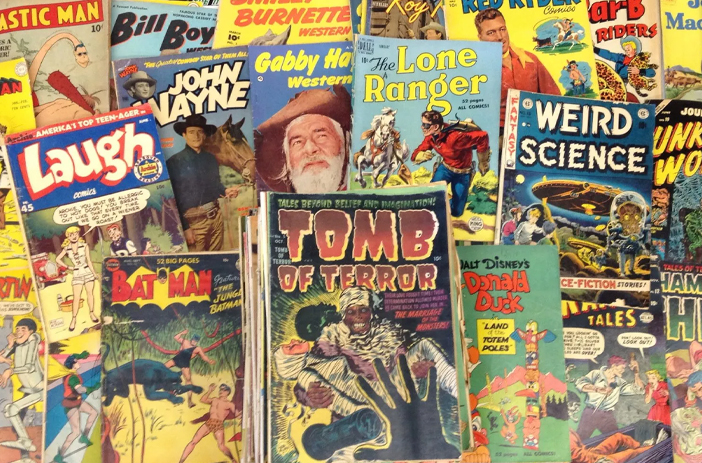 Person sorting through stack of comic books