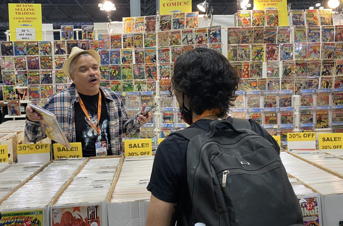 Person browsing comics at a store