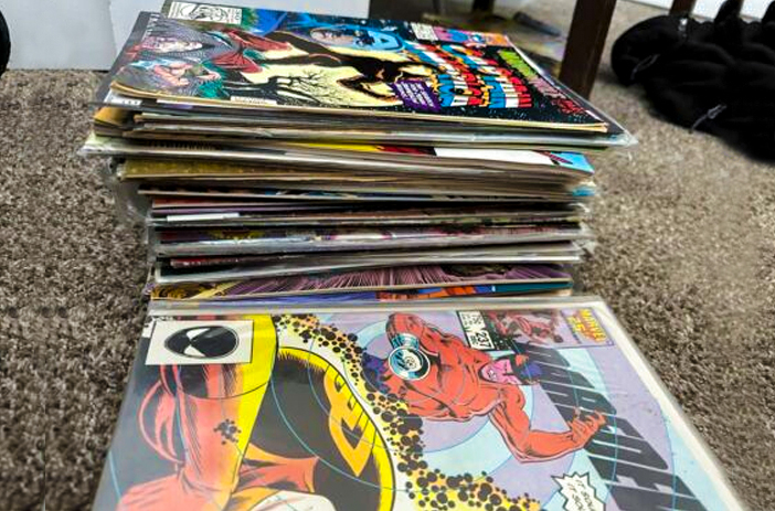 Person examining comic book suspiciously