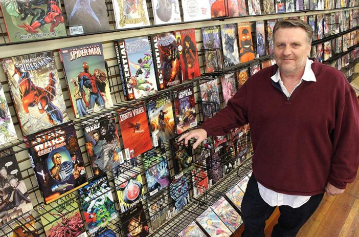 Collector examining bagged and boarded comic books