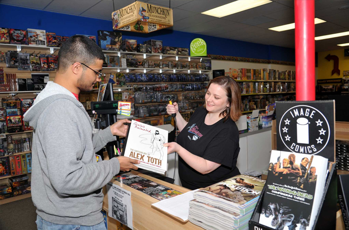 Buyer reviewing comics with a broker