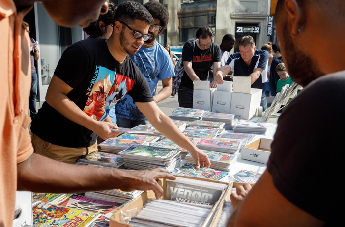 Person organizing and pricing comic book collection