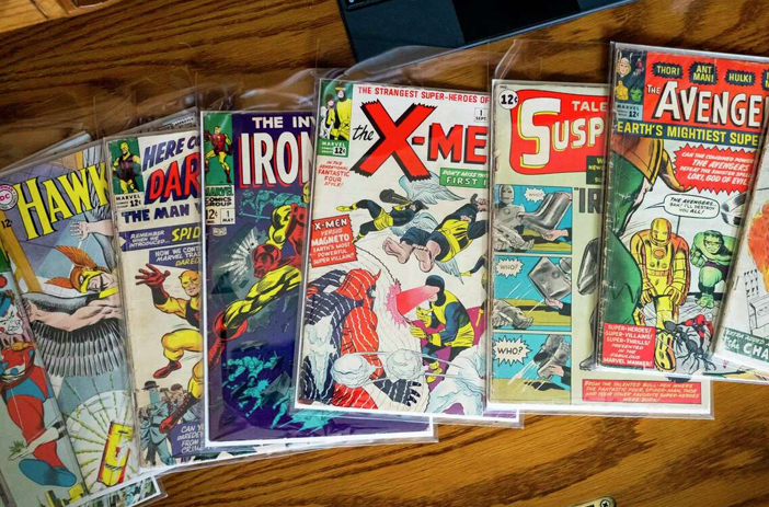 Two people exchanging comic books privately