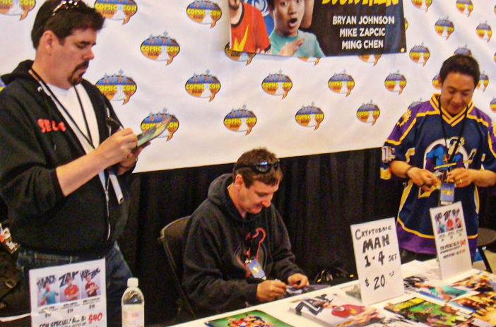 Person signing comic book in store