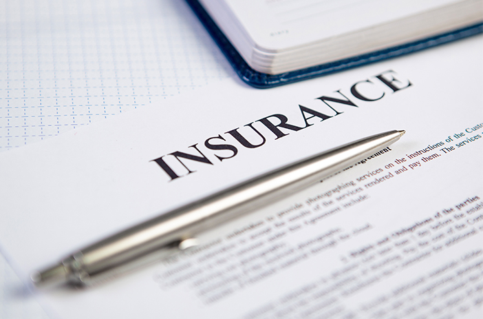 Stack of comic books with insurance documents