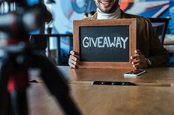 Person holding comic book giveaway prize