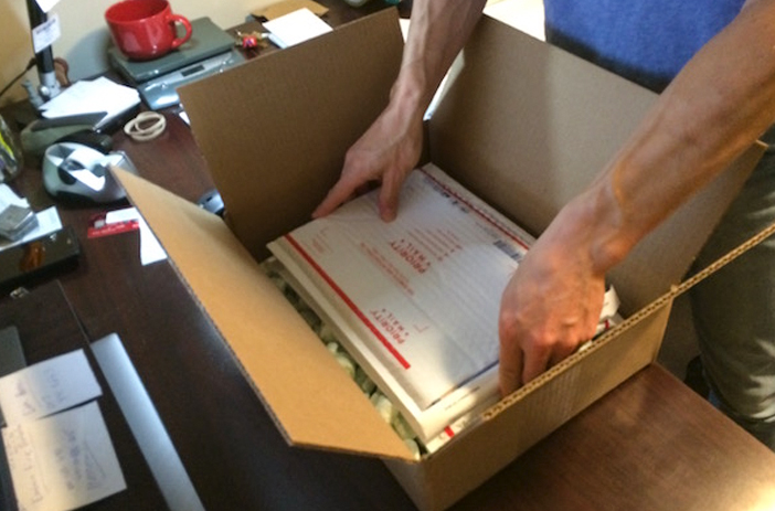 Comics secured snugly inside padded mailer