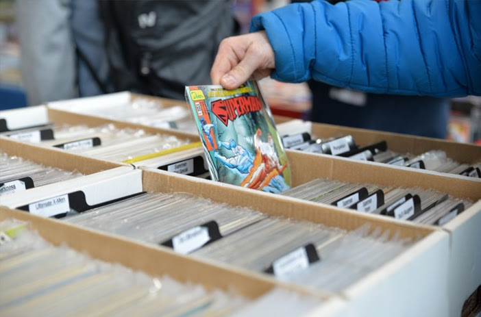 Person carefully examining a comic book