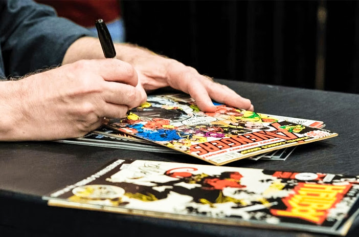 Person selling comics at a convention table
