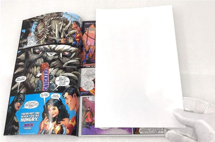 Comic book stored in protective plastic sleeve