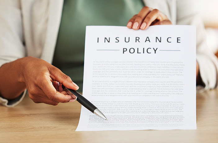 Person reviewing insurance policy documents carefully