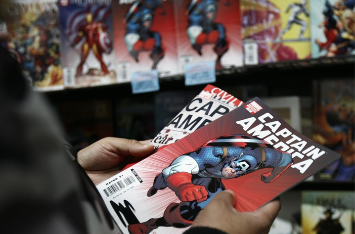 A Person Holding Comic Books