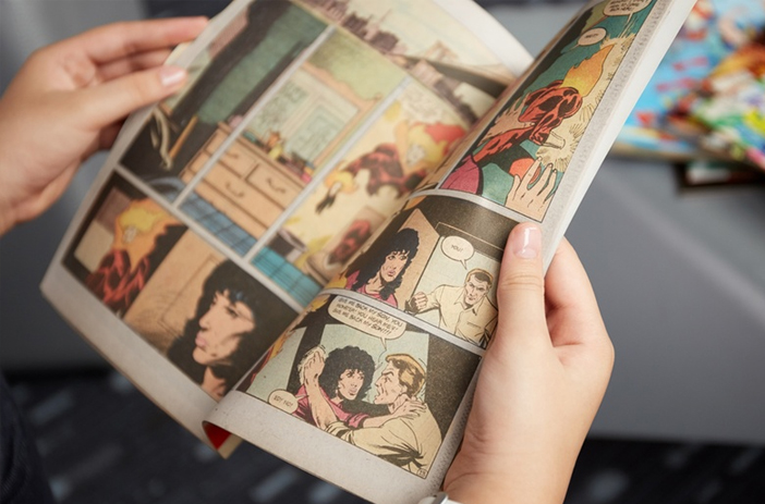 A Person Reading a First Edition Comic Book