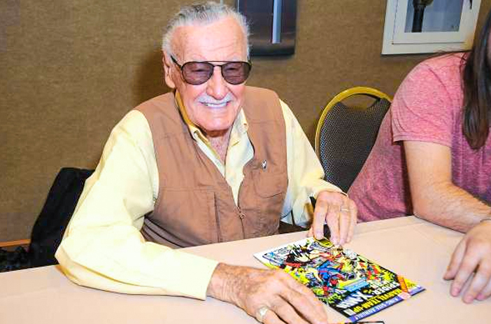 Stan Lee Signing a Comic Book
